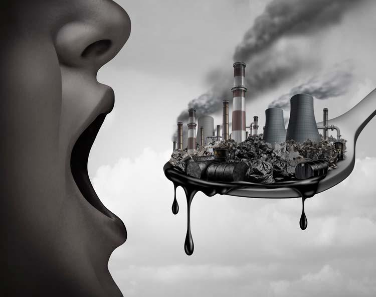 Grayscale illustration of an open mouth facing a spoon loaded with factories, smokestacks and dripping oil
