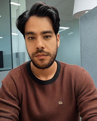 Juan, a dark-haired, bearded man in a brown sweater